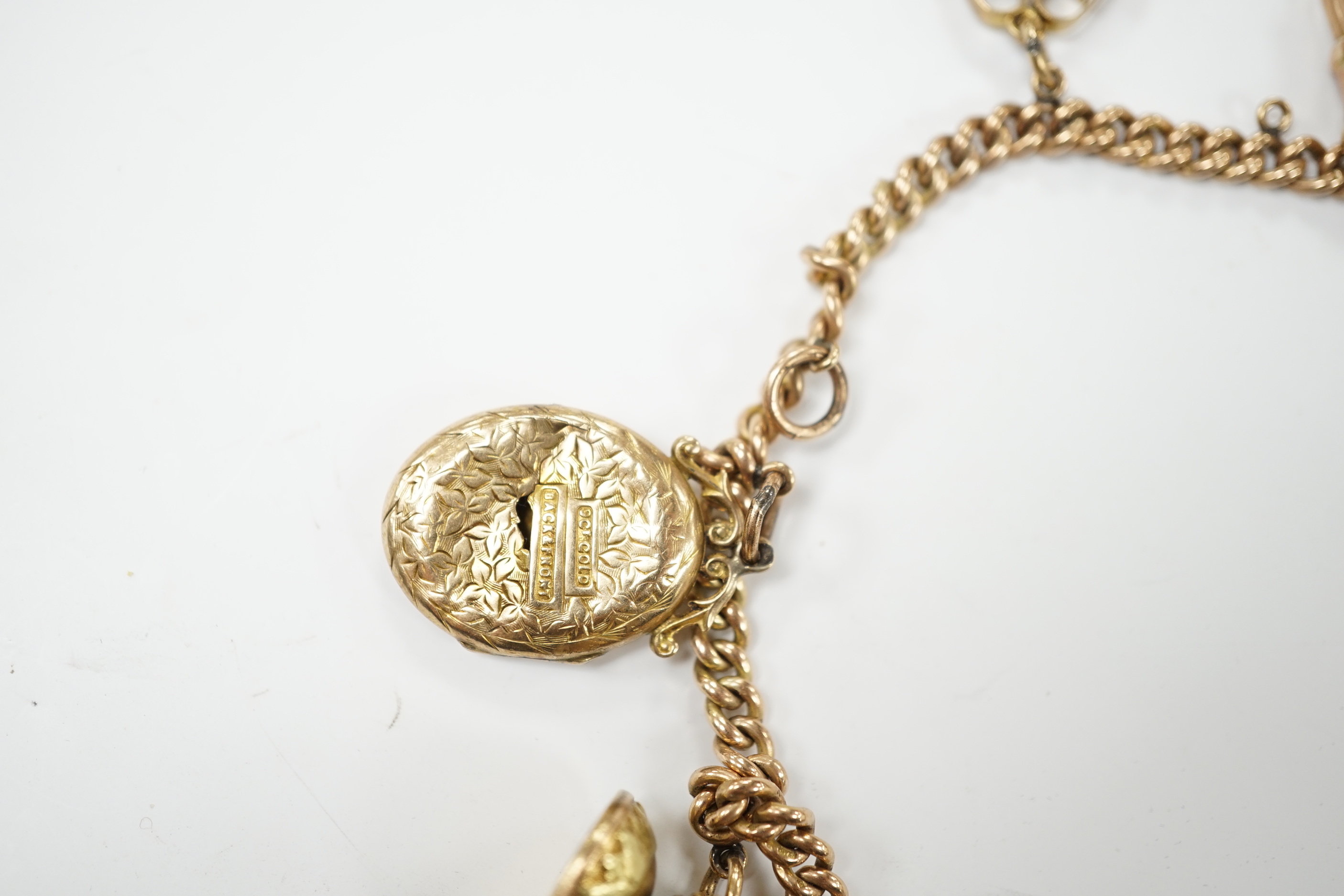 A 9ct gold curblink chain hung with fifteen assorted charms including a 1906 sovereign and an 1865 20 francs coin, gross 80.8 grams